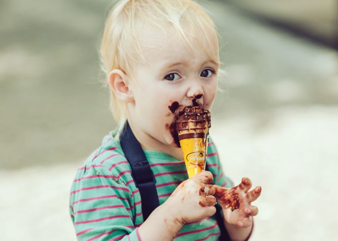 Little boy getting messy with an ice cream cone